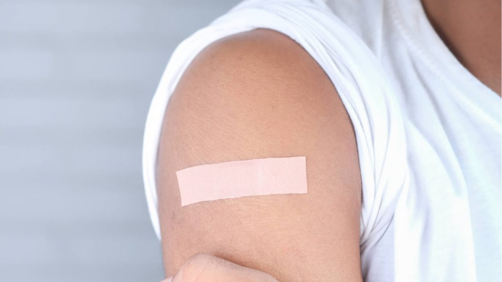 Close-up of an arm with sticking plaster after vaccine