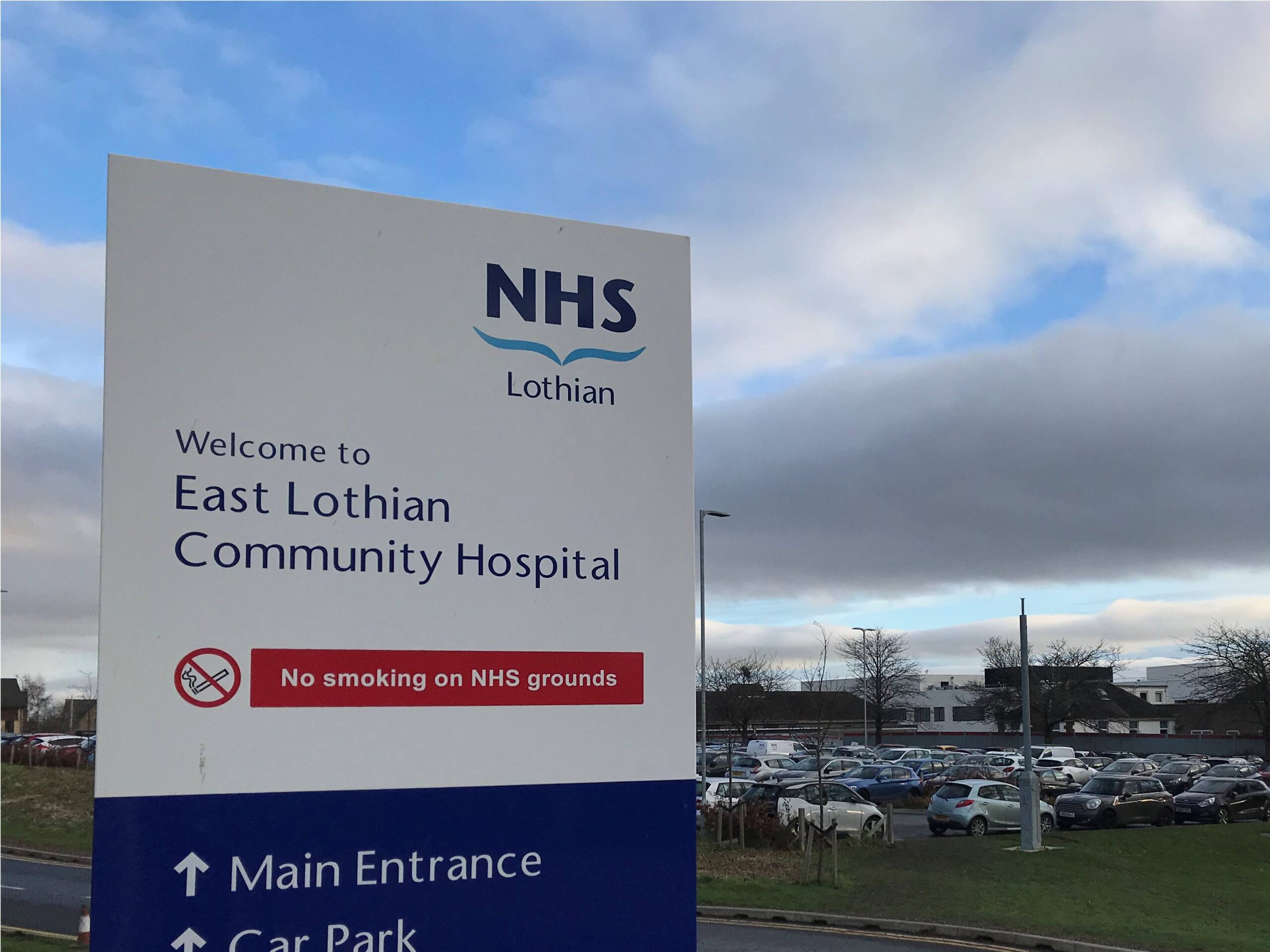 Sign saying welcome to East Lothian Community Hospital at road entrance to the site