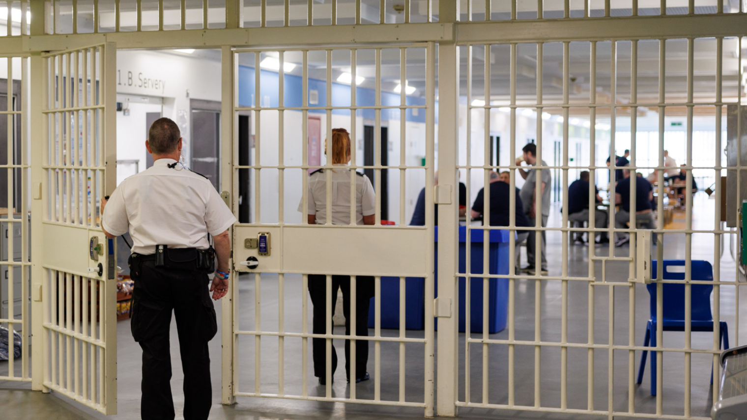 Prison staff supervising prisoners within a prison in Scotland.