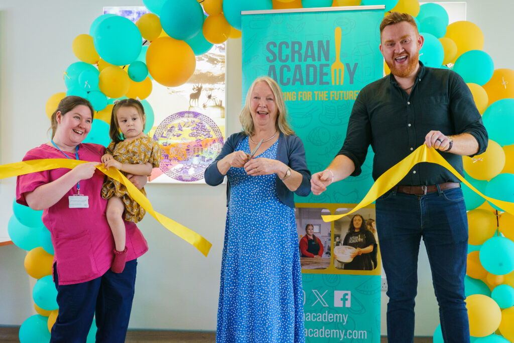NHS Lothian Play Specialist Tasha Coe and patient Elodie cut the ribbon of the new cafe with Edinburgh Council Leader, Jane Meagher, and Scran Academy Founder, John Loughton