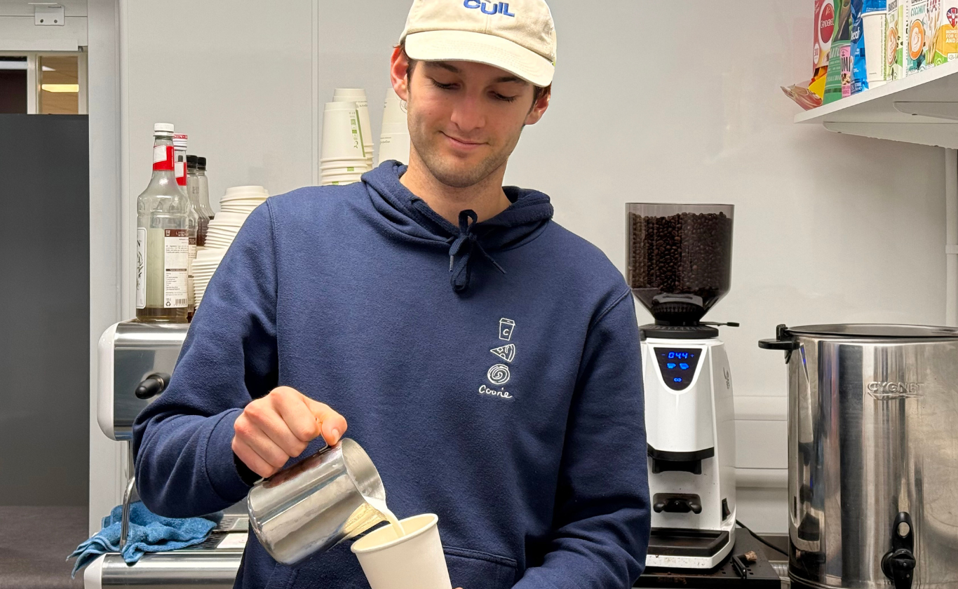 Barista pouring a coffee at the new kiosk at Lauriston Buildings